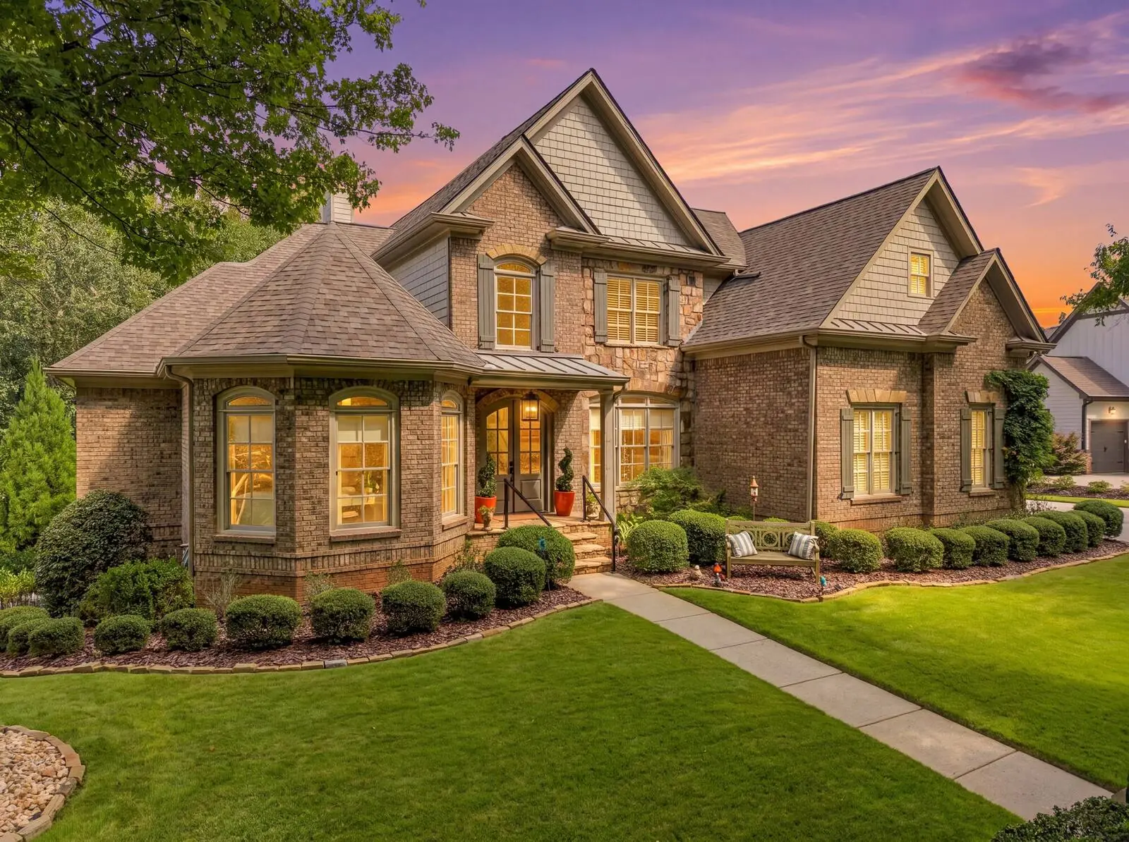 Brick traditional home exterior at twilight